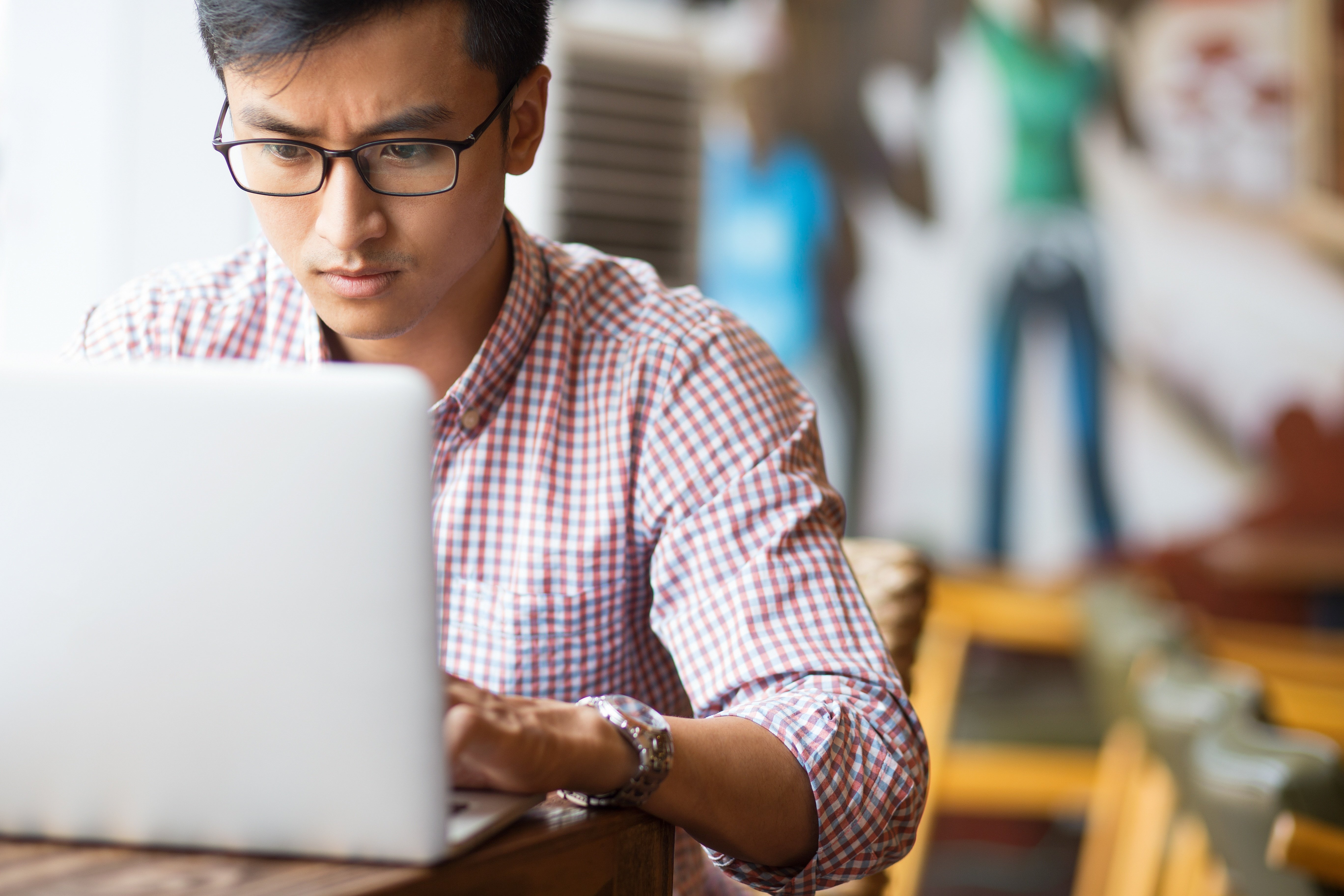 A young man working at a computer